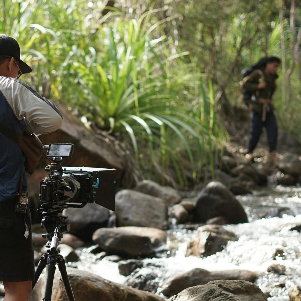Live virtual tour, the guide crossing the stream in forest