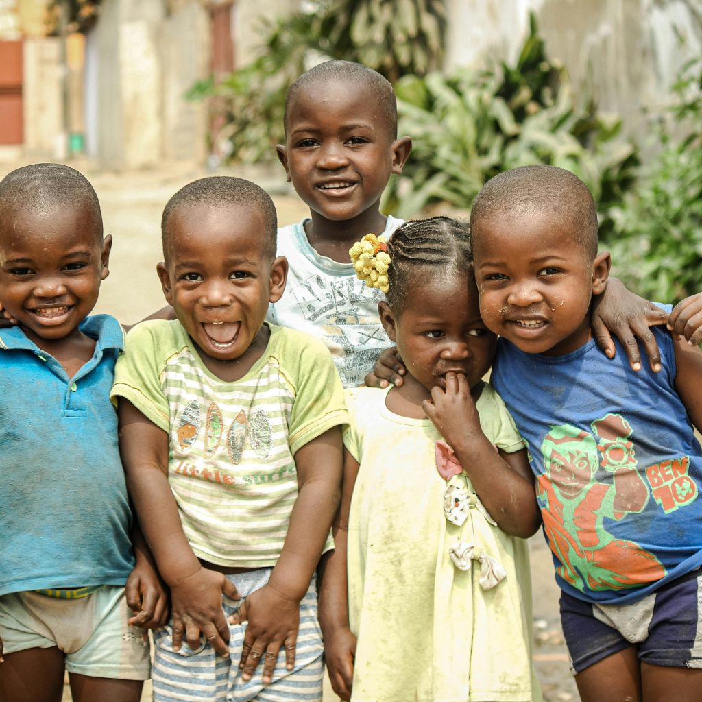  Local Rwandan children smiling in colorful traditional dress
